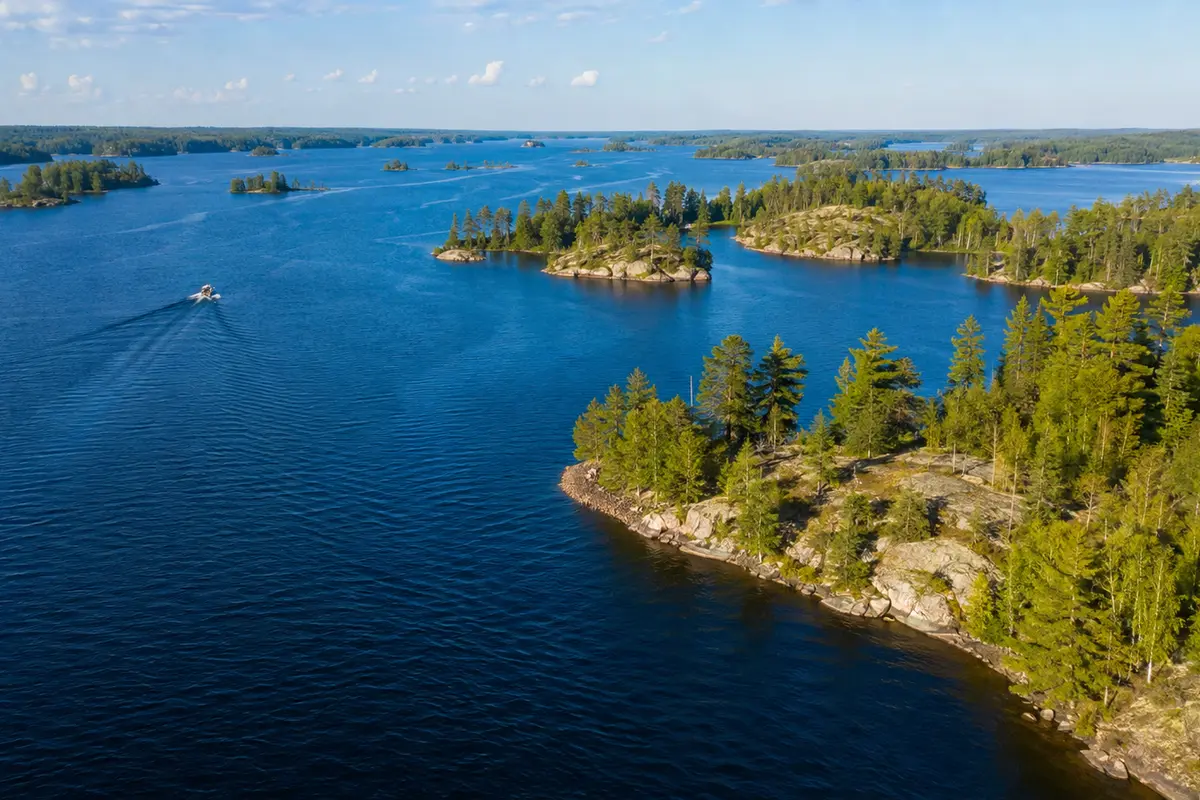A broad blue Ontario lake dotted with forested granite islands.